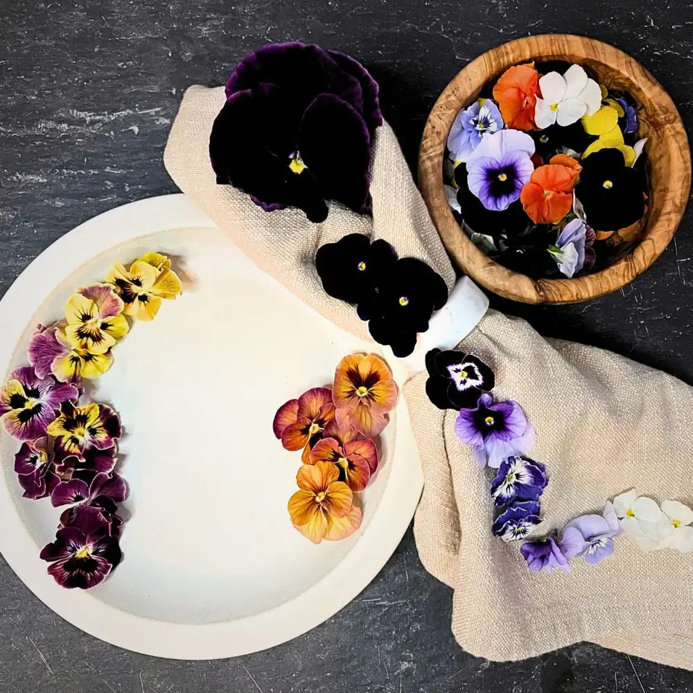 Assorted edible flowers mix used as colorful garnish for salads and dishes.